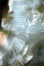 Person Holding Musical Composition Sheet