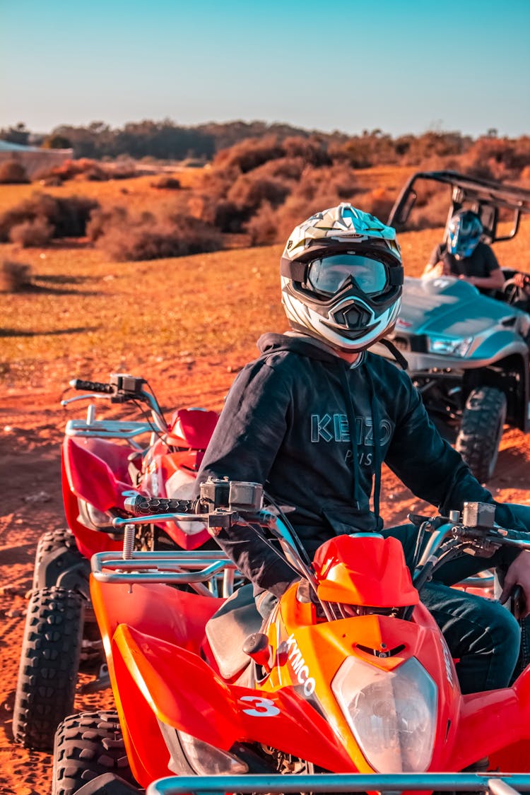 A Man Wearing Helmet Driving An ATV