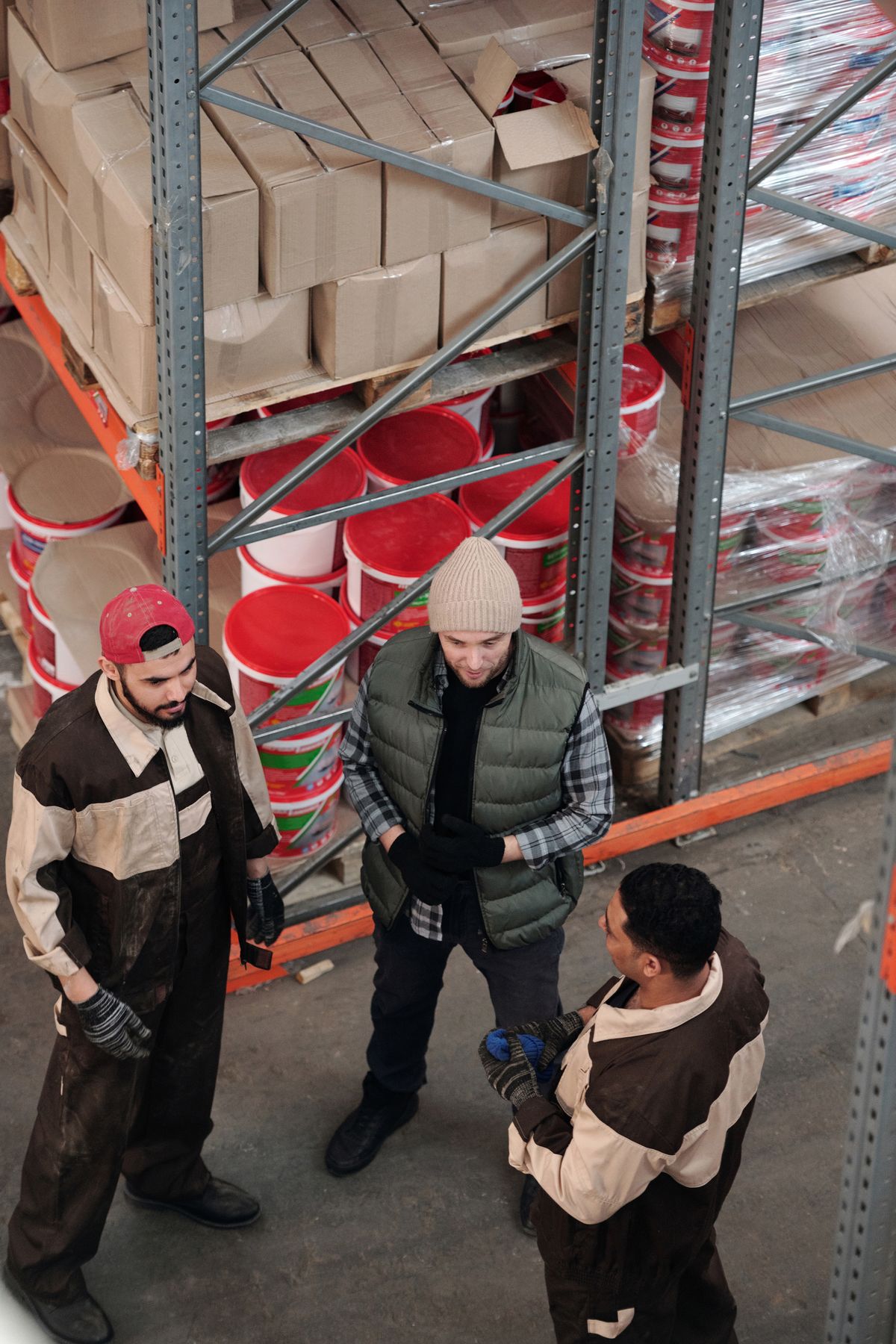 Warehouse workers discussing inventory and operations