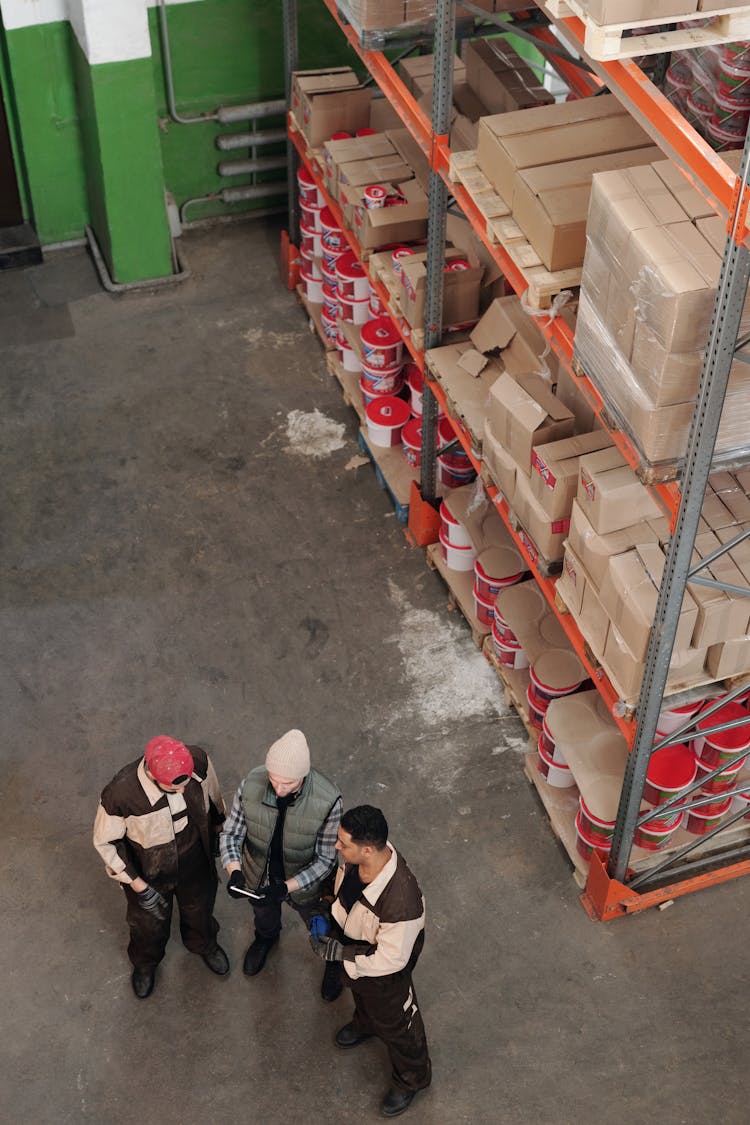 Men Standing In A Warehouse Talking