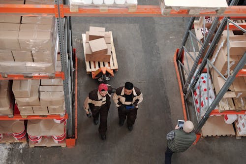 Free Men Working in a Warehouse Stock Photo