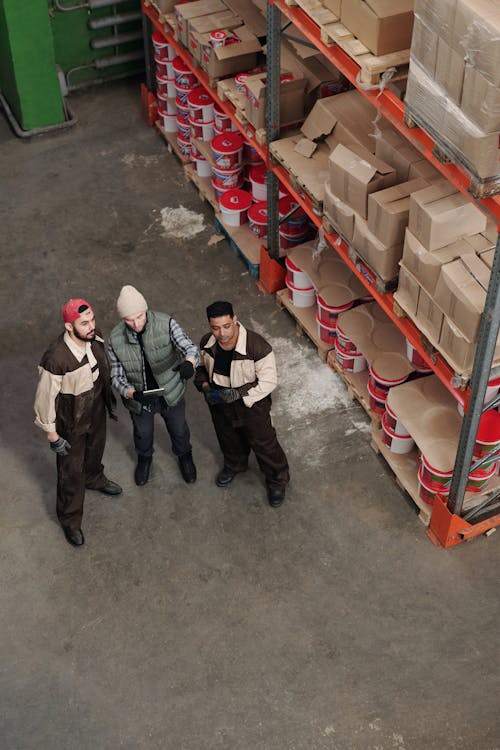Men Standing in a Warehouse Talking