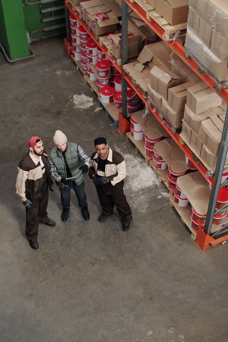 Men Standing In A Warehouse Talking