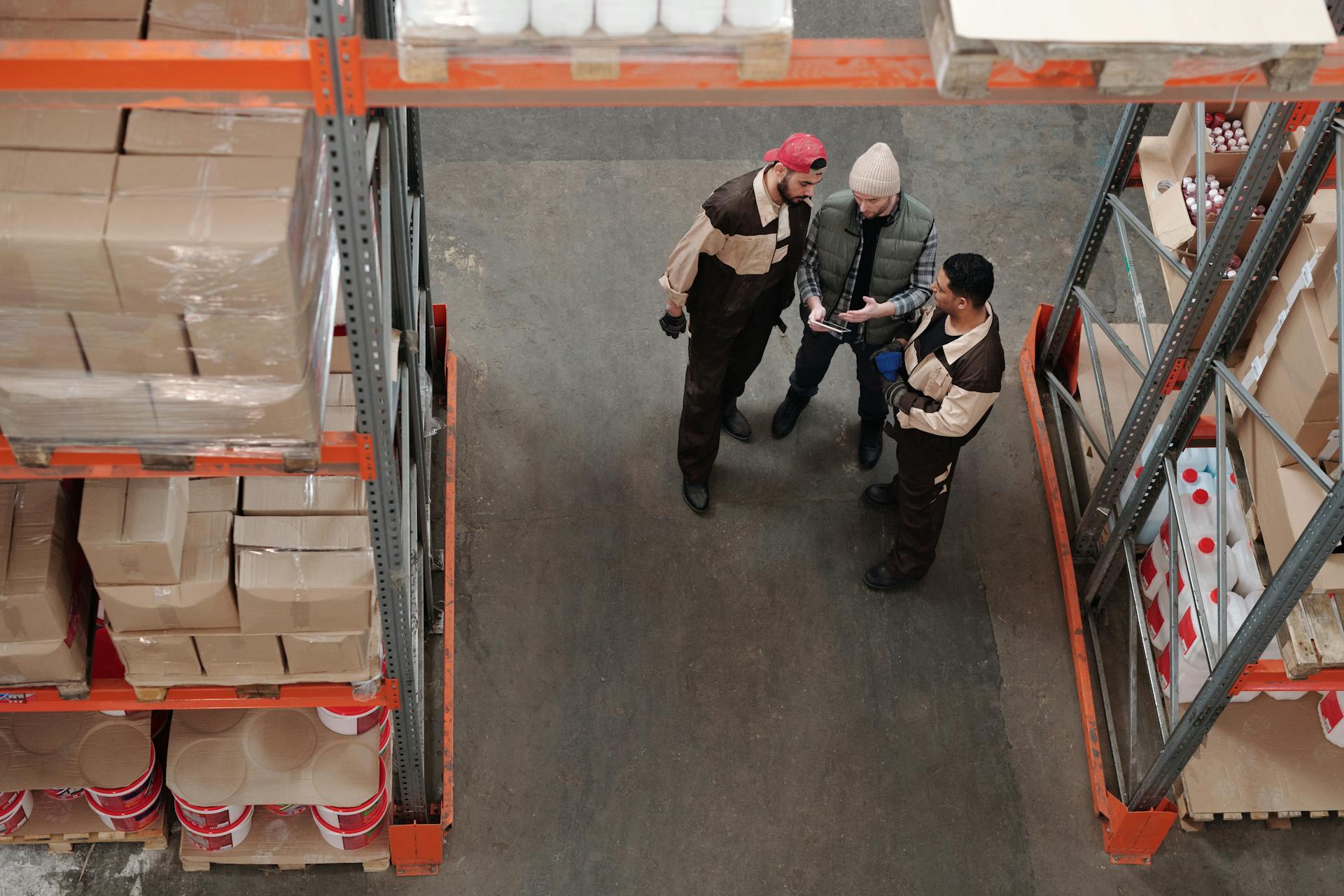 Men Standing in a Warehouse Talking