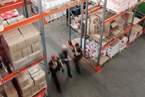 Free Men Walking in a Warehouse Stock Photo
