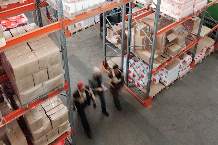 Men Walking In A Warehouse