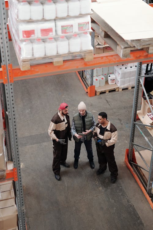 Men Standing in a Warehouse Talking