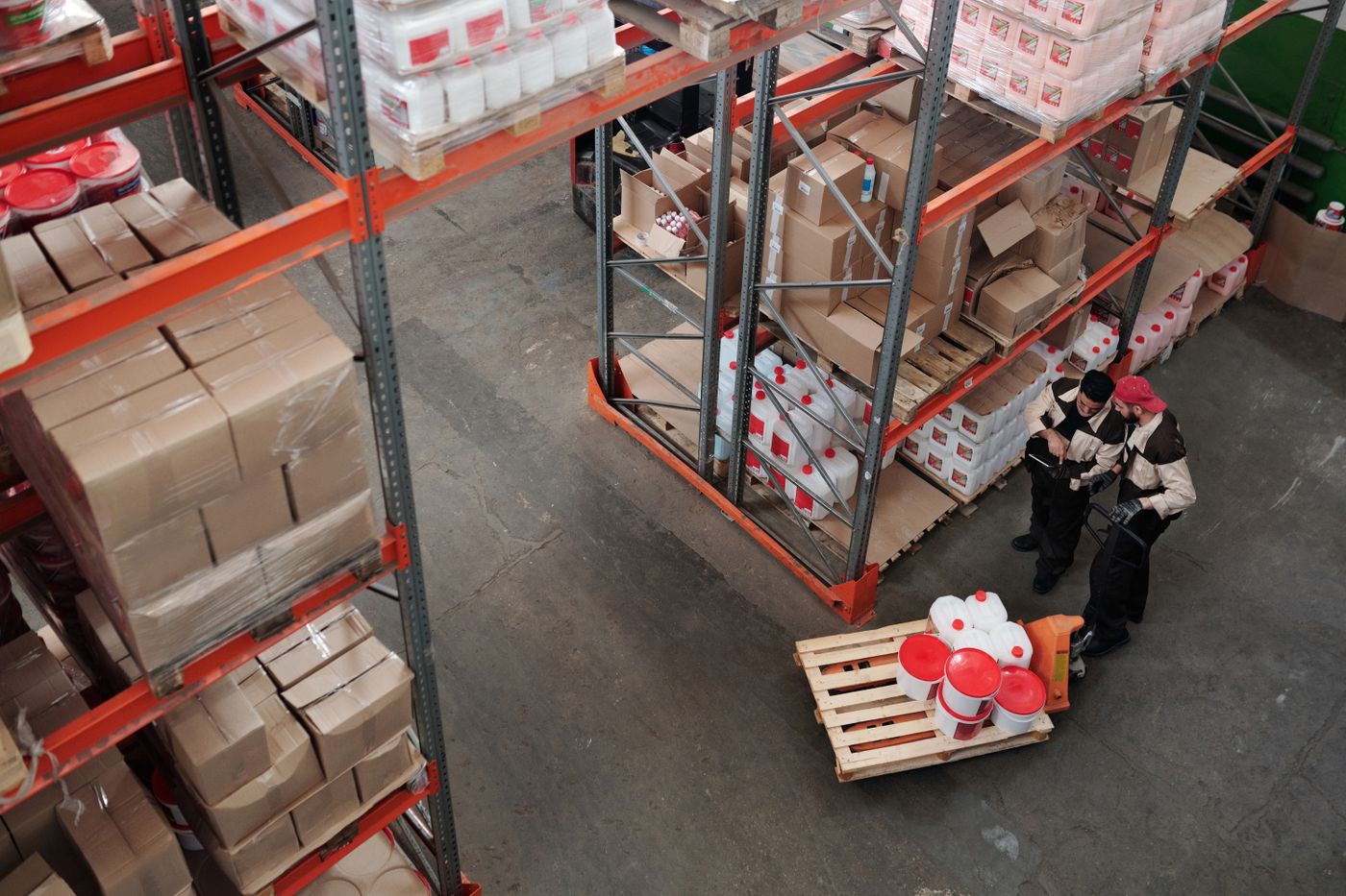 Workers managing inventory in a warehouse