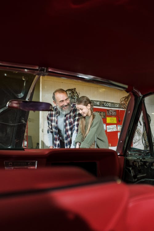 Free Man in Brown Button Up Shirt Driving Red Car Stock Photo