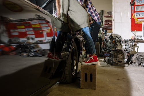 Free A Girl and her Father Standing by a Car at an Auto Repair Shop Stock Photo