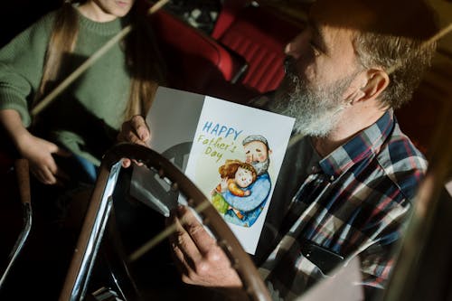 Free Man in Black White and Red Plaid Shirt Holding White Printer Paper Stock Photo