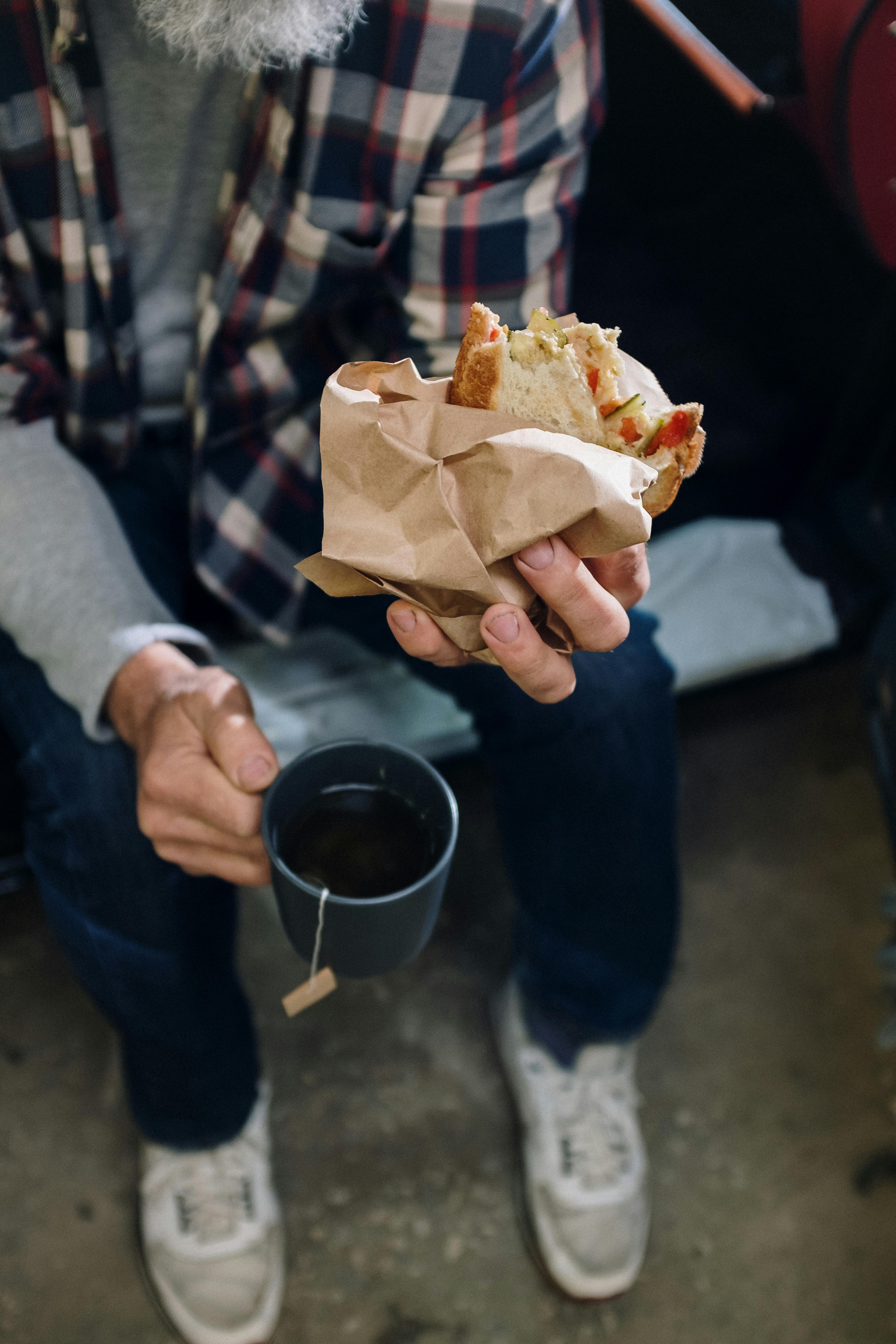 person holding a bread with white cream