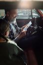 Man in Green Sweater Holding Smartphone