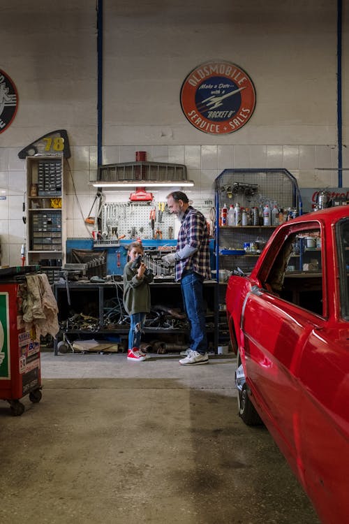 Free Father and Daughter at an Auto Repair Shop Stock Photo