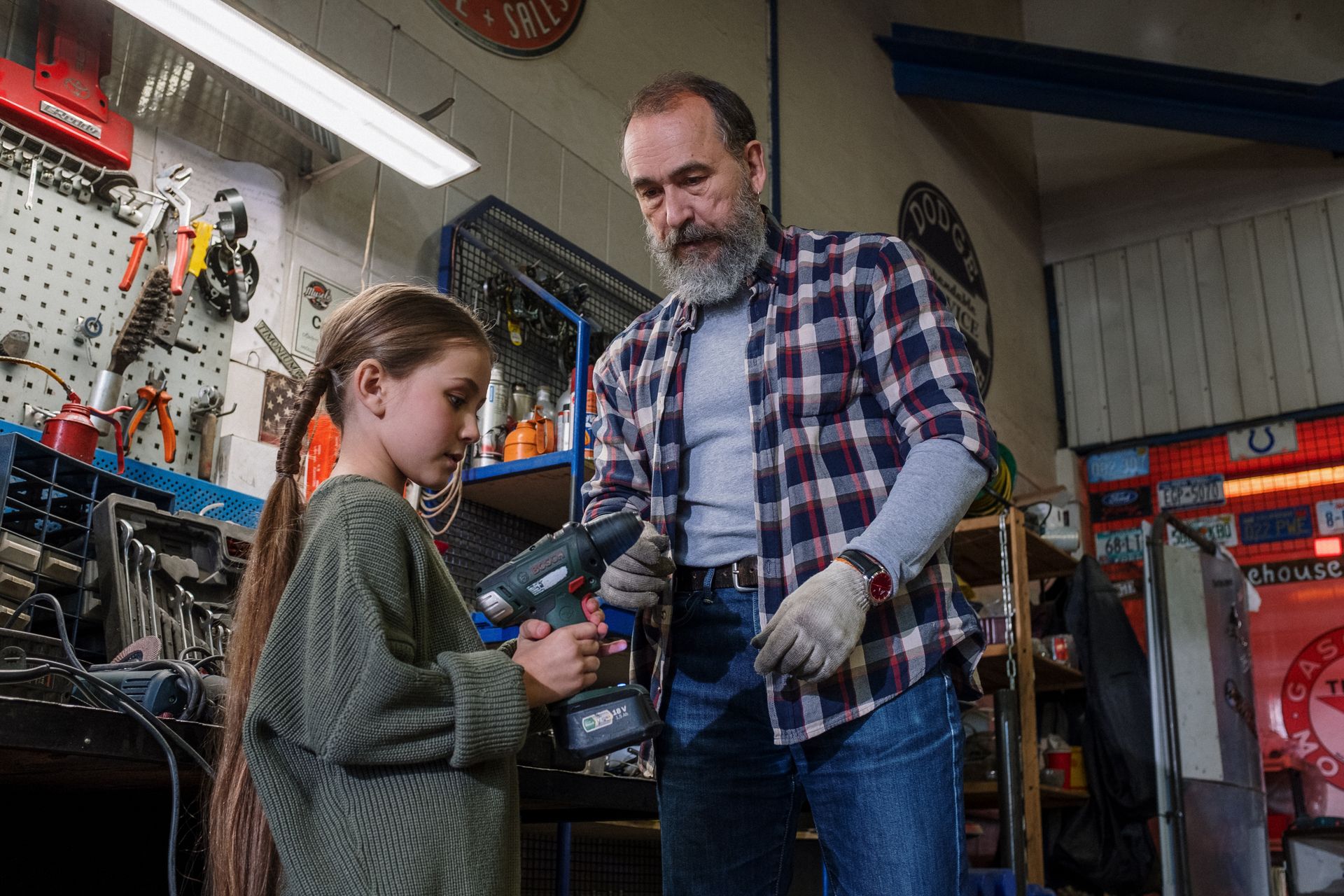 A Father Teaching his Daughter How to Use a Power Tool