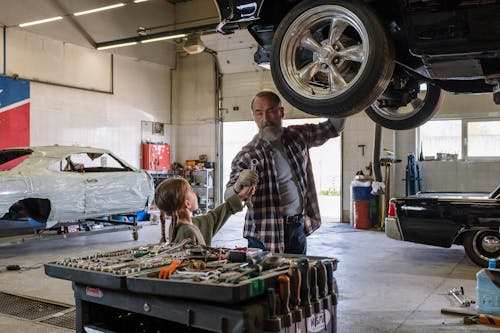 Father and Daughter Working Together at a Car Repair Shop