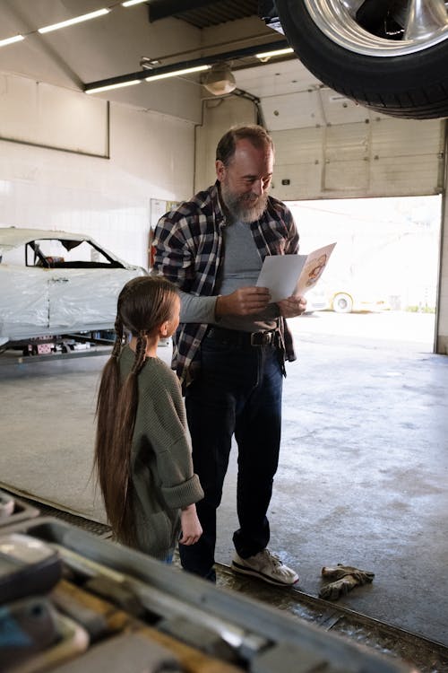 Free A Man Receiving a Greeting Card from his Little Daughter  Stock Photo