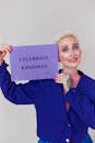 Woman in Blue Blazer Holding Brown Card