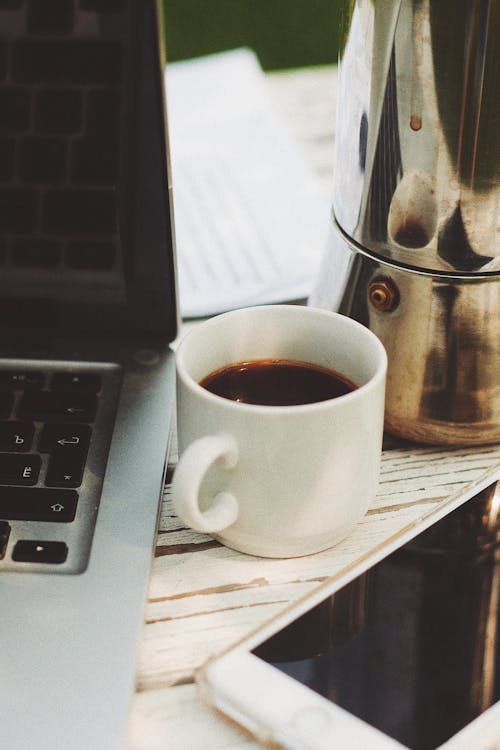 Hot Drink Beside Laptop and Cellphone