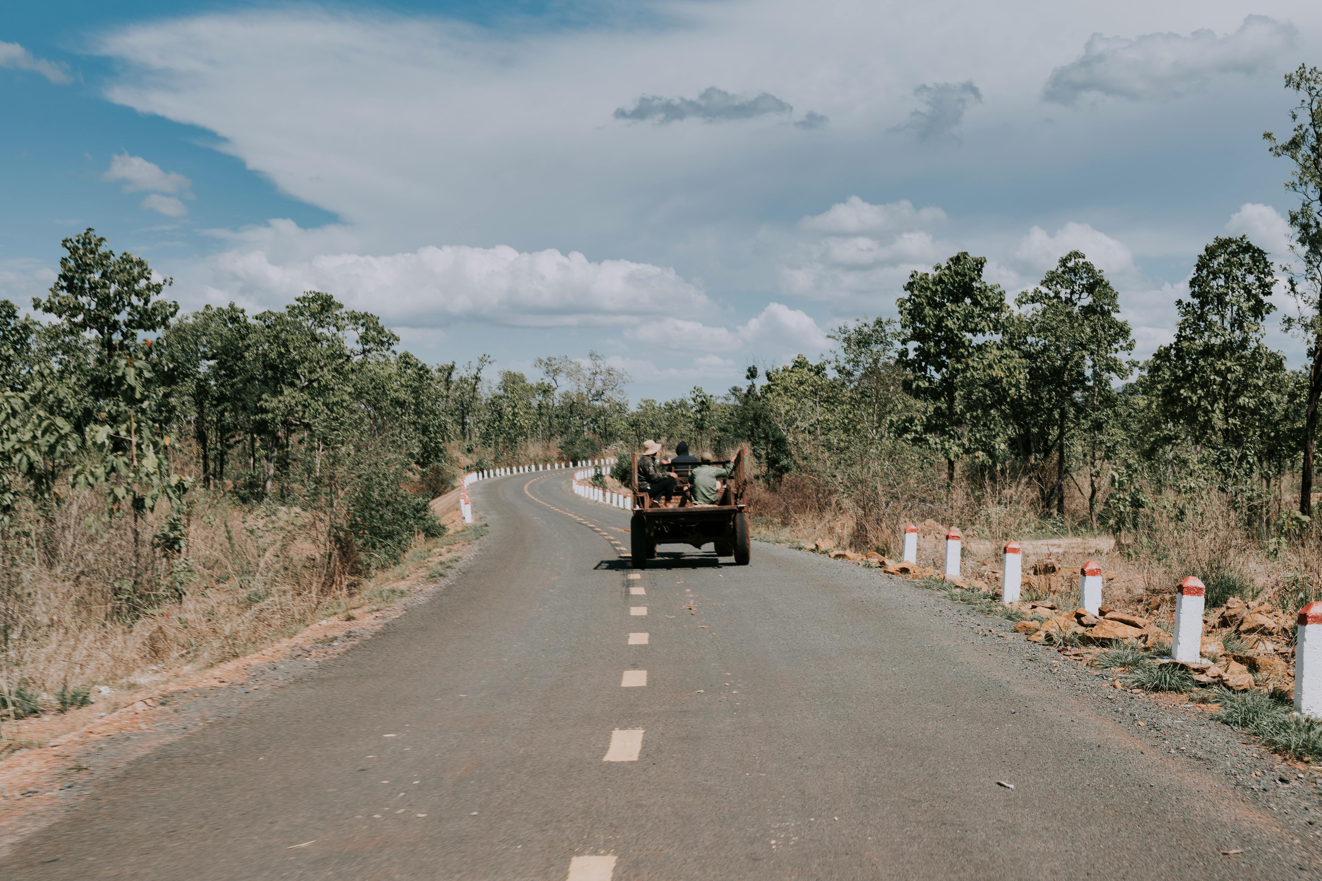 Car driving along road in summer countryside · Free Stock Photo