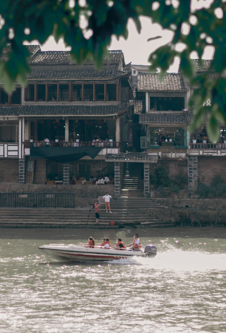 Motor Boat Floating Near Old Building