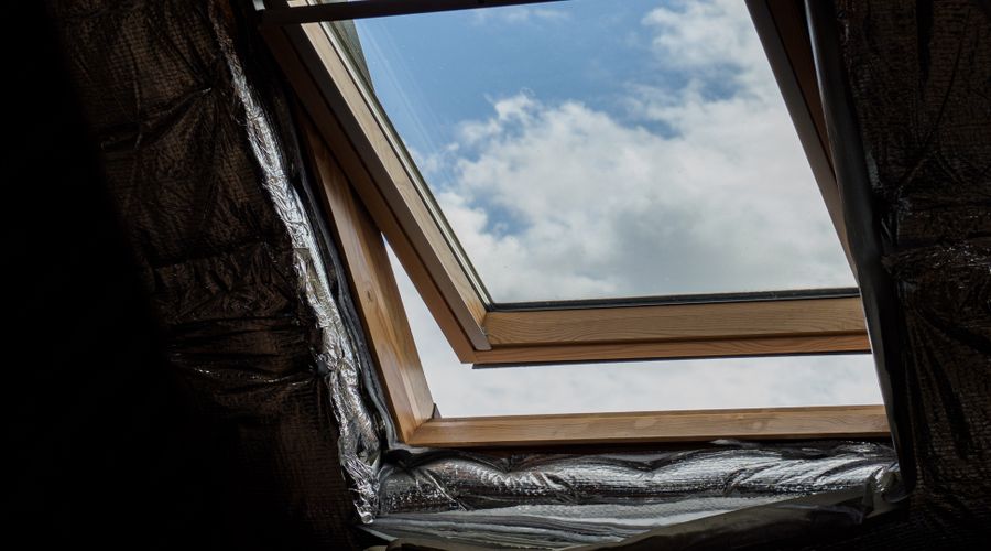 Spray foam insulation being applied in a home attic space