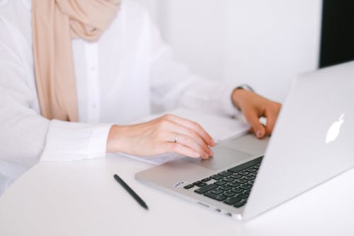 Free Person in White Dress Shirt Using Macbook Pro Stock Photo