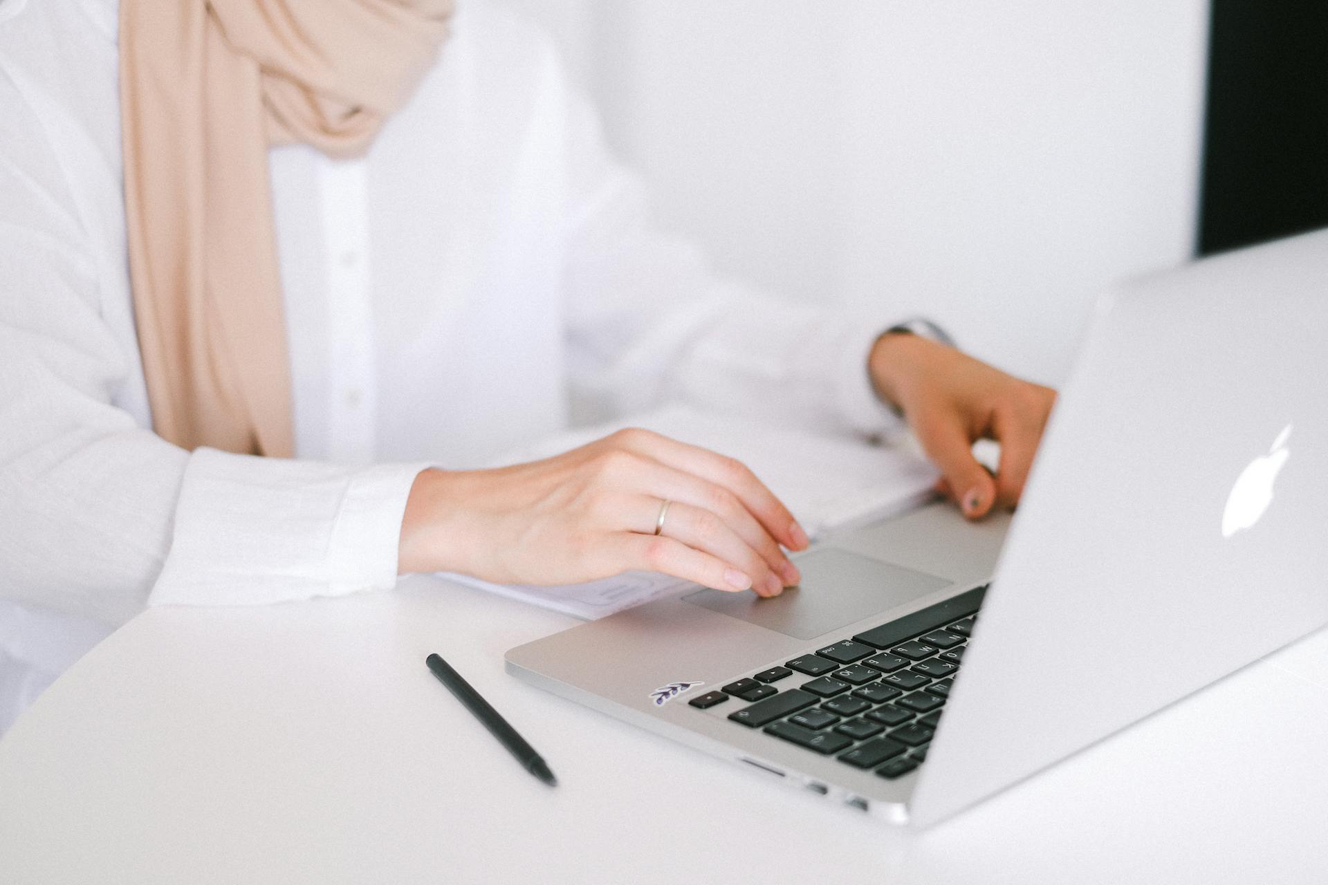 Person in White Dress Shirt Using Macbook Pro