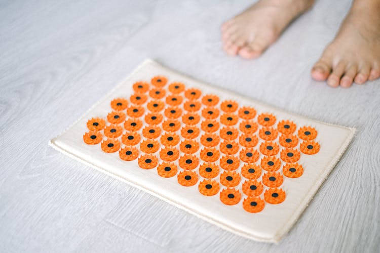 Close-up Of A Person Next To Medical Massage Mat