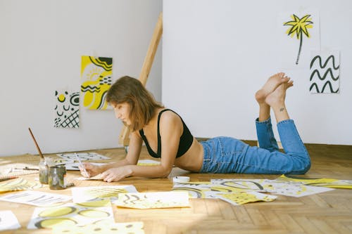 Free Photo of Woman Lying on Floor While Painting Stock Photo