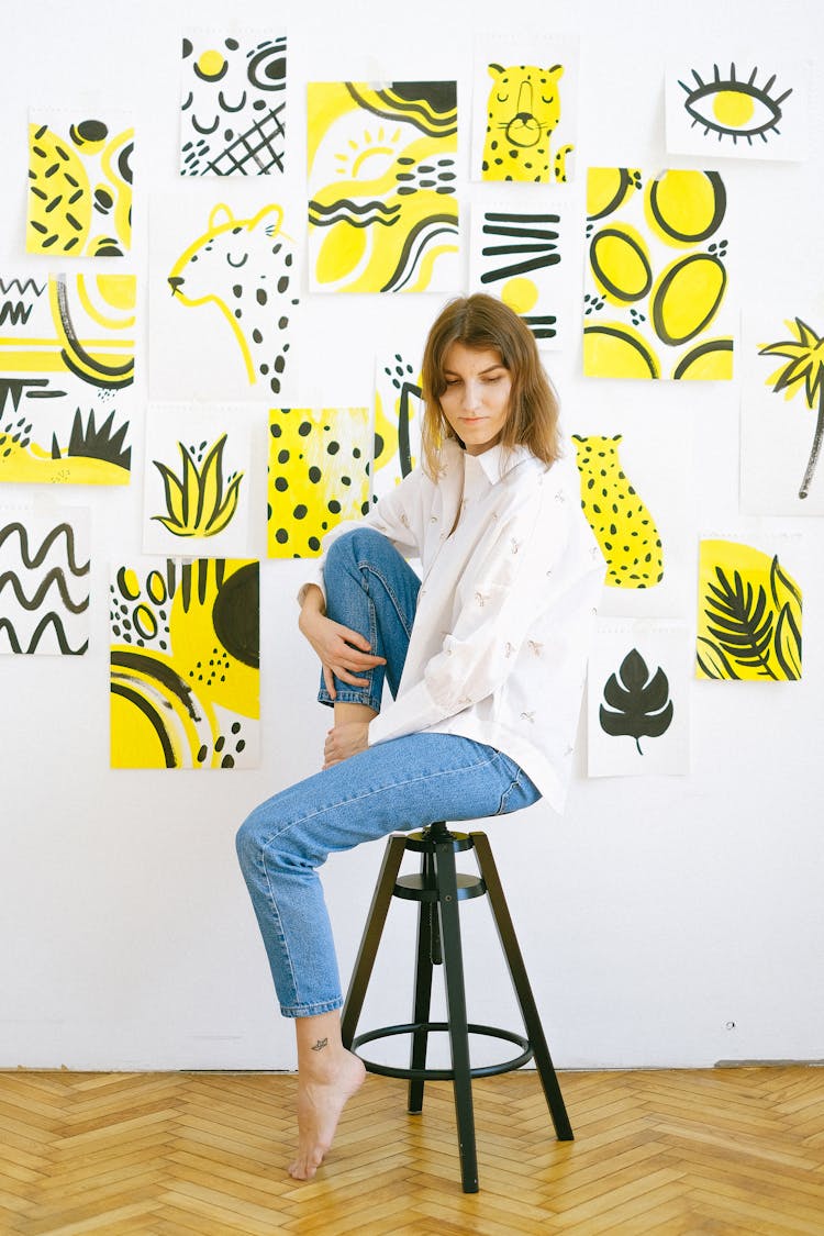 Photo Of Woman Sitting On A Black Stool 