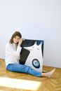 Woman in White Long Sleeve Shirt and Blue Denim Jeans Sitting Floor