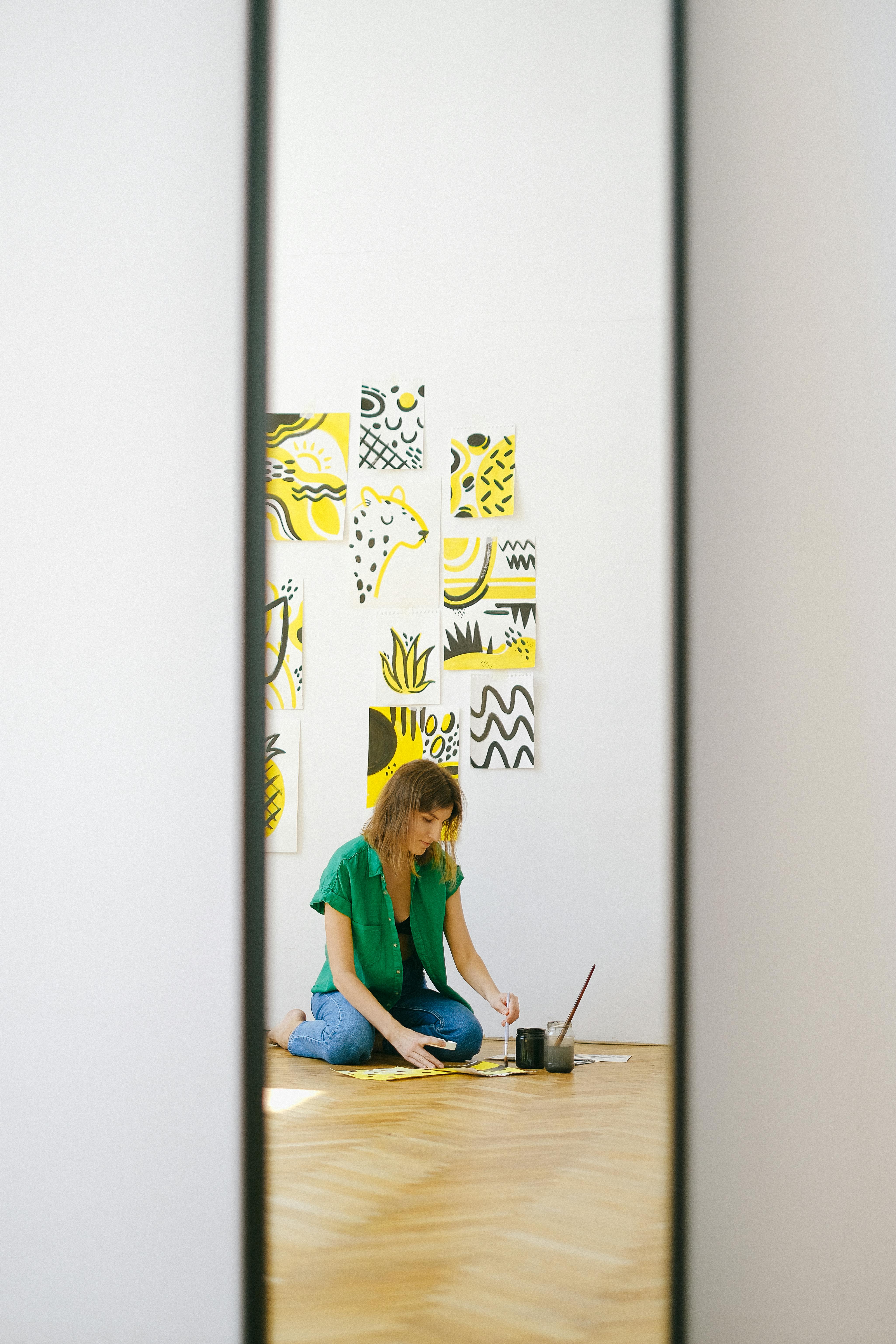 Person in Blue Denim Jeans Sitting While Painting \u00b7 Free Stock Photo