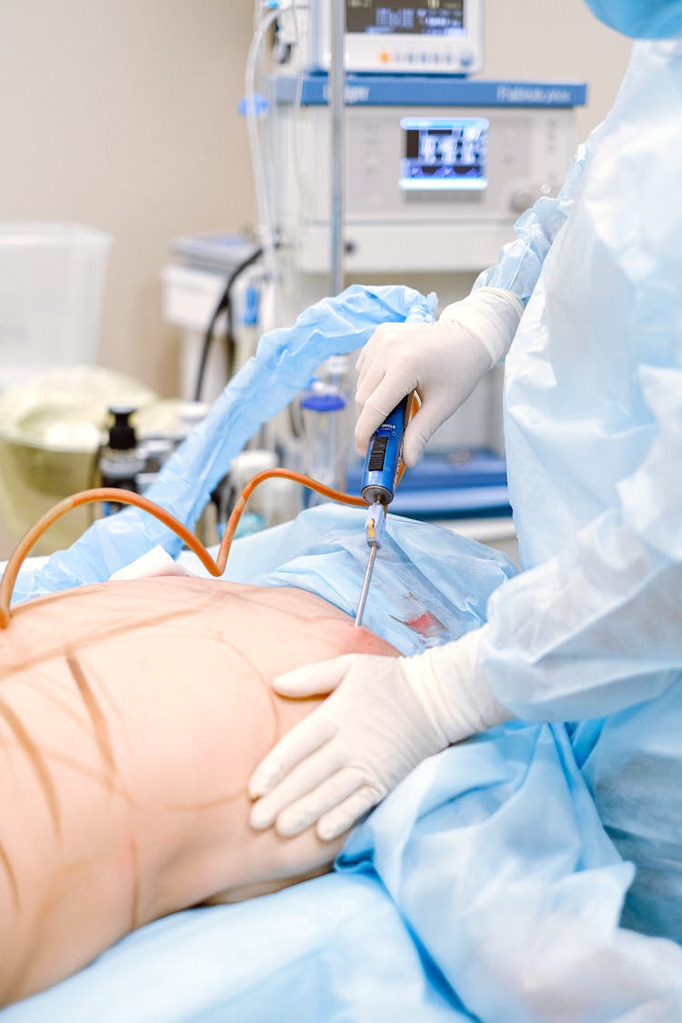 Photo Of Medical Professional Doing A Liposuction On A Patient