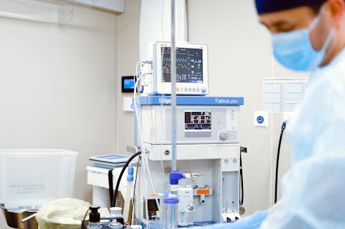 A Medical Professional Wearing Face Mask while Standing Near Operating Room