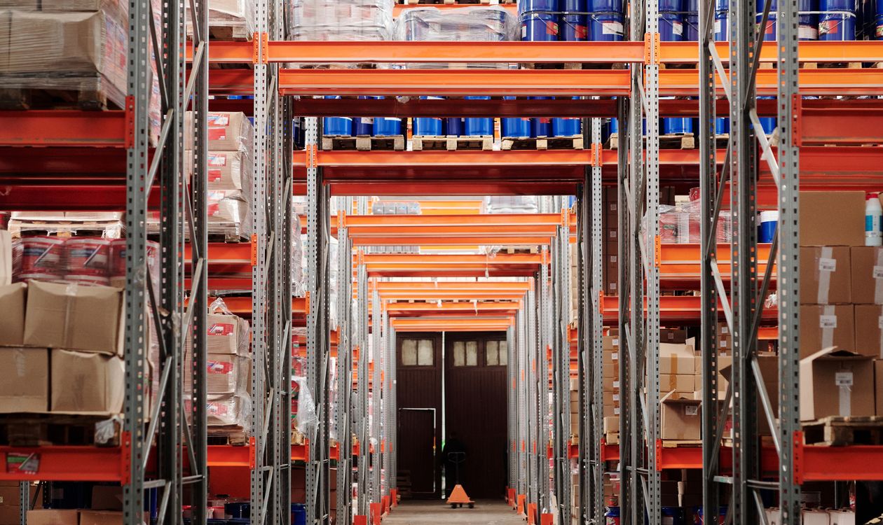 Warehouse shelving and pallets, illustrating the supply chain processes behind SAP work