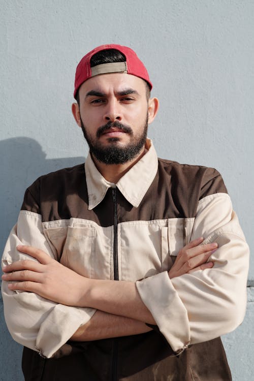 Man in Brown and White Button Up Shirt and Red Cap