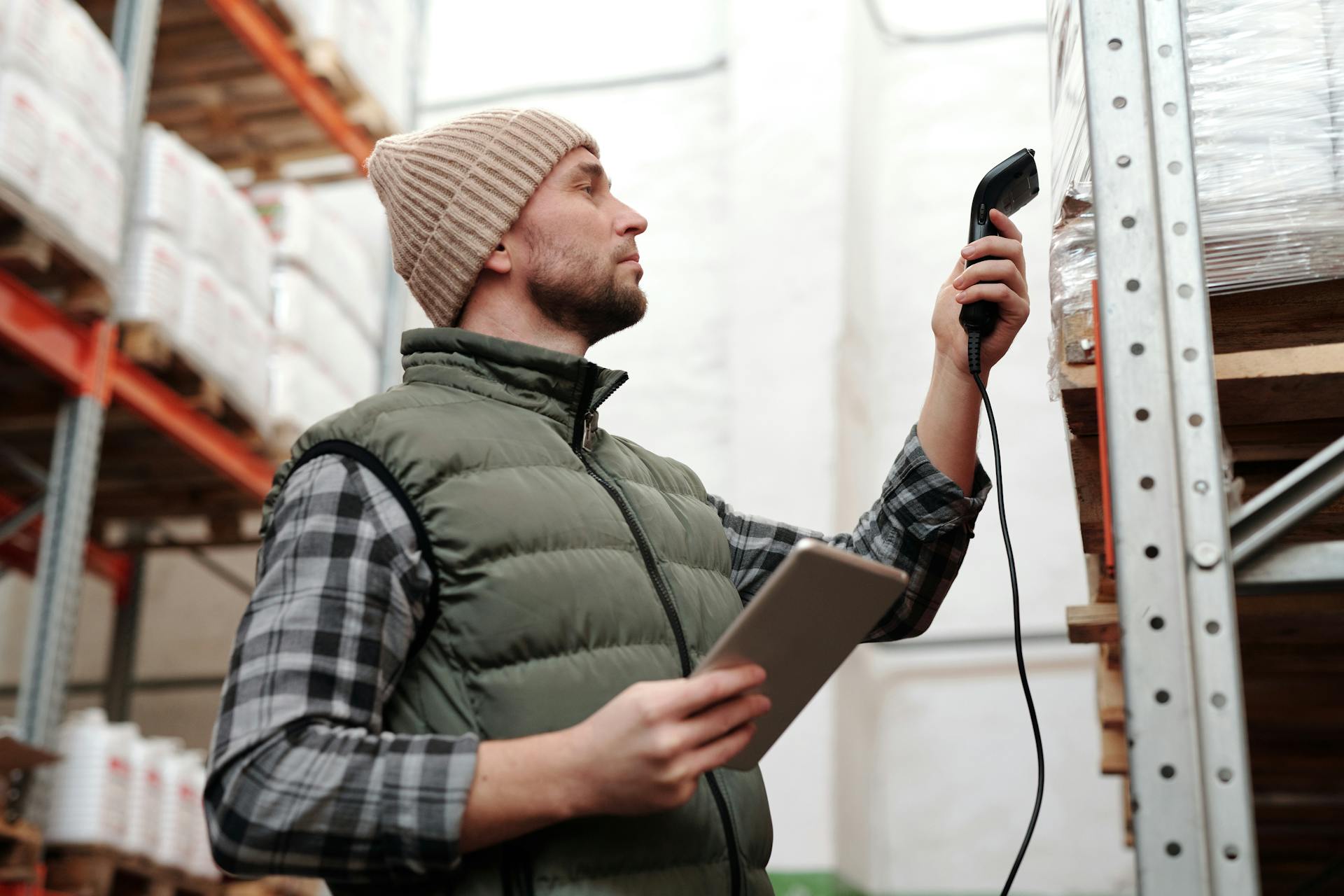 Photo of a Man Scanning Products in a Warehouse