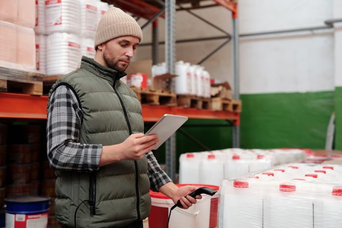 Warehouse manager checking inventory on a tablet — photo by Tiger Lily on Pexels
