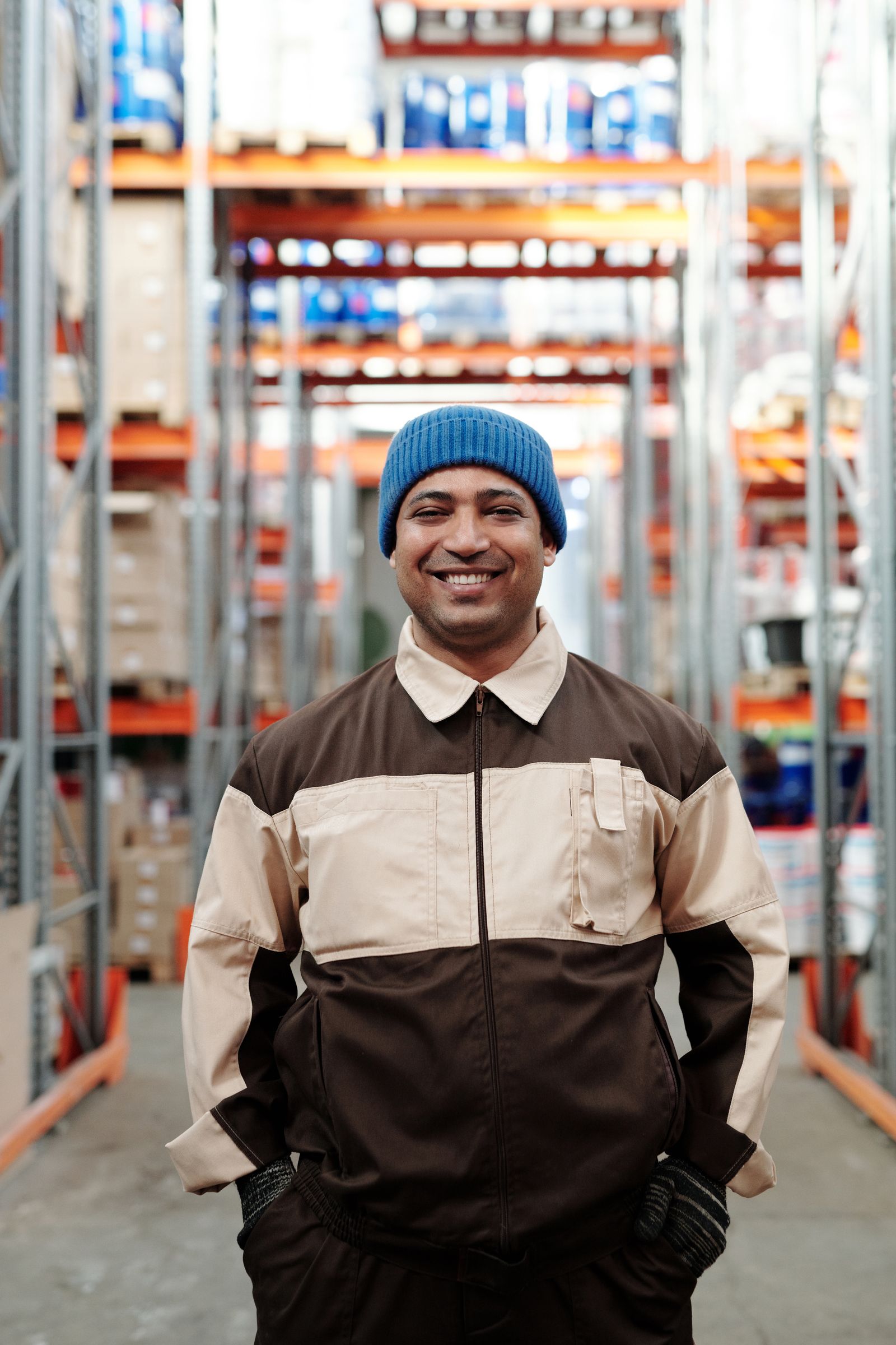 Worker lifting a box in a bright warehouse setting