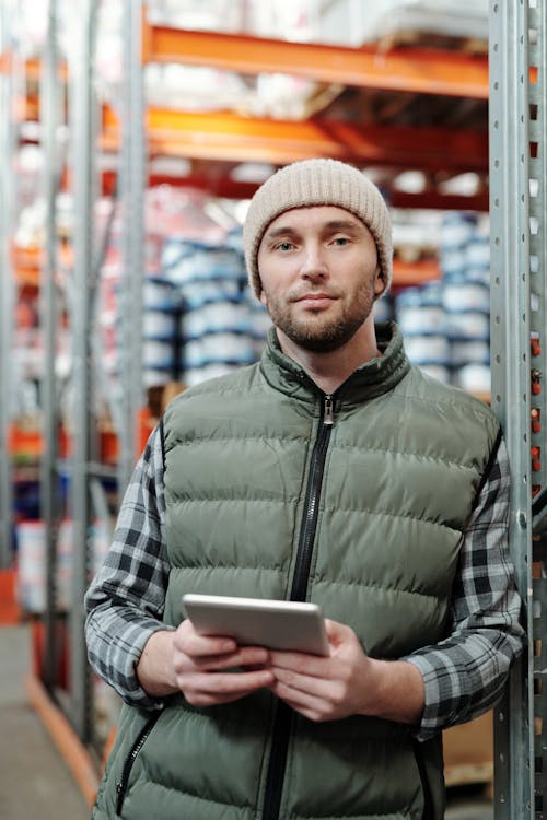 Photo of Man Wearing Beanie While Holding Tablet Computer