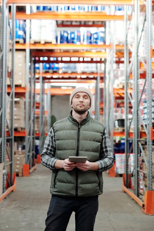 Free Photo of Man in Bubble Jacket While Holding Tablet Computer Stock Photo