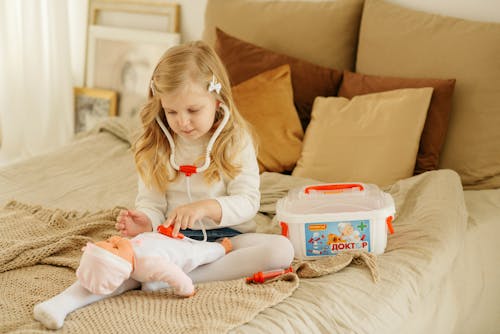 Free Girl Playing With Baby Doll Stock Photo