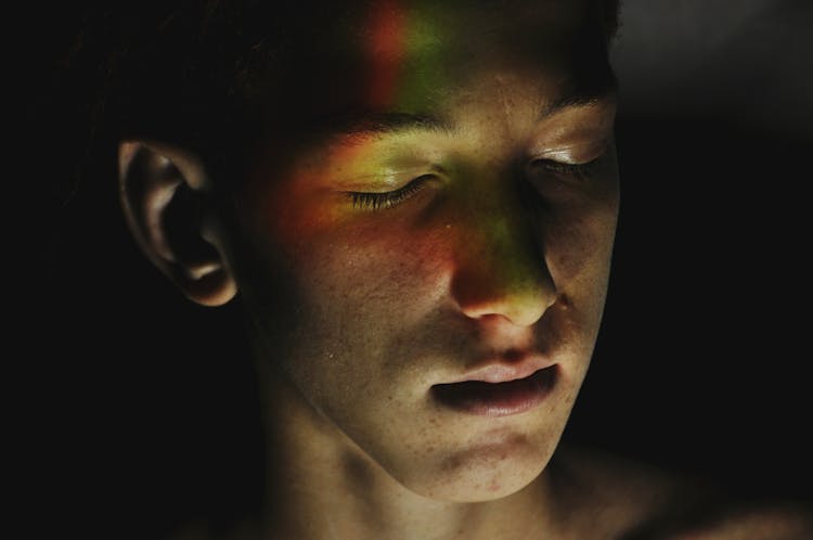 Freckled Teenager With Neon Lights On Face