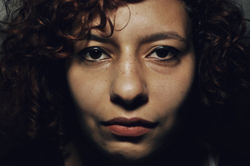 Free Close-up portrait capturing the deep, contemplative expression of a young woman. Stock Photo