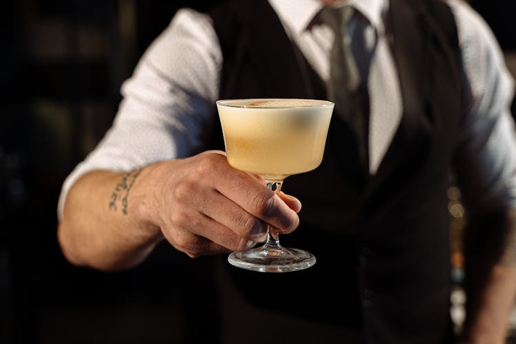 A Person Holding A Cocktail Drink 