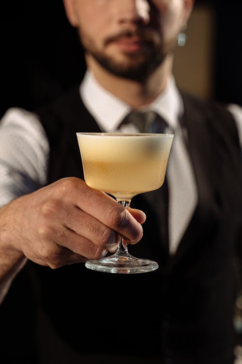 Waiter Hand Holding Cocktail Glass