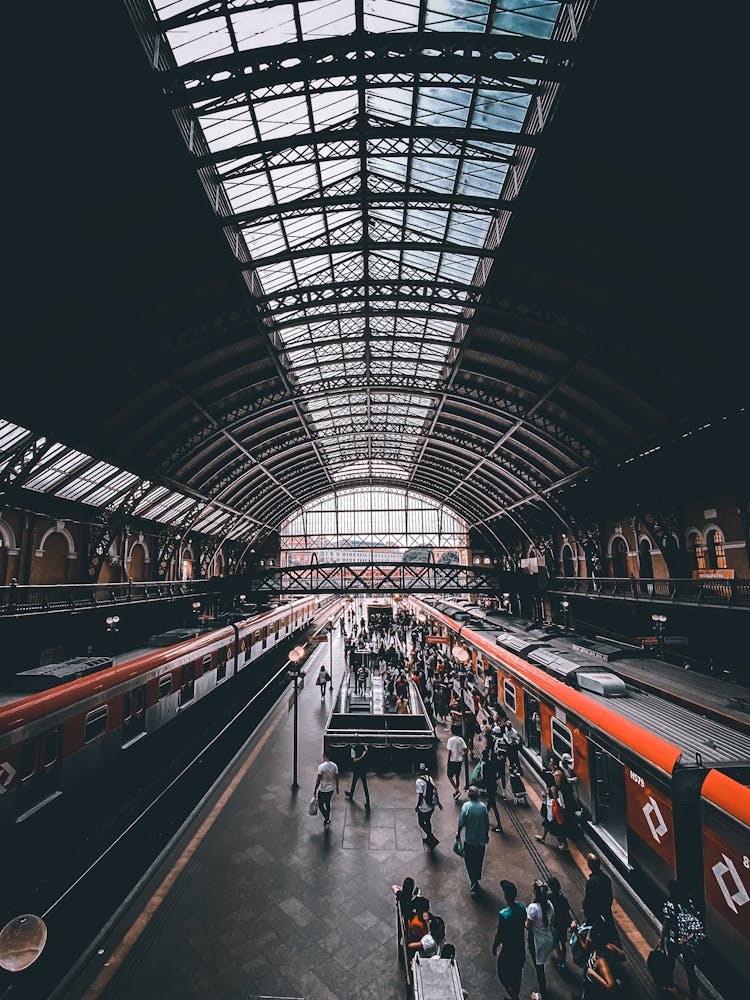 People In Motion On Platform Of Train Station