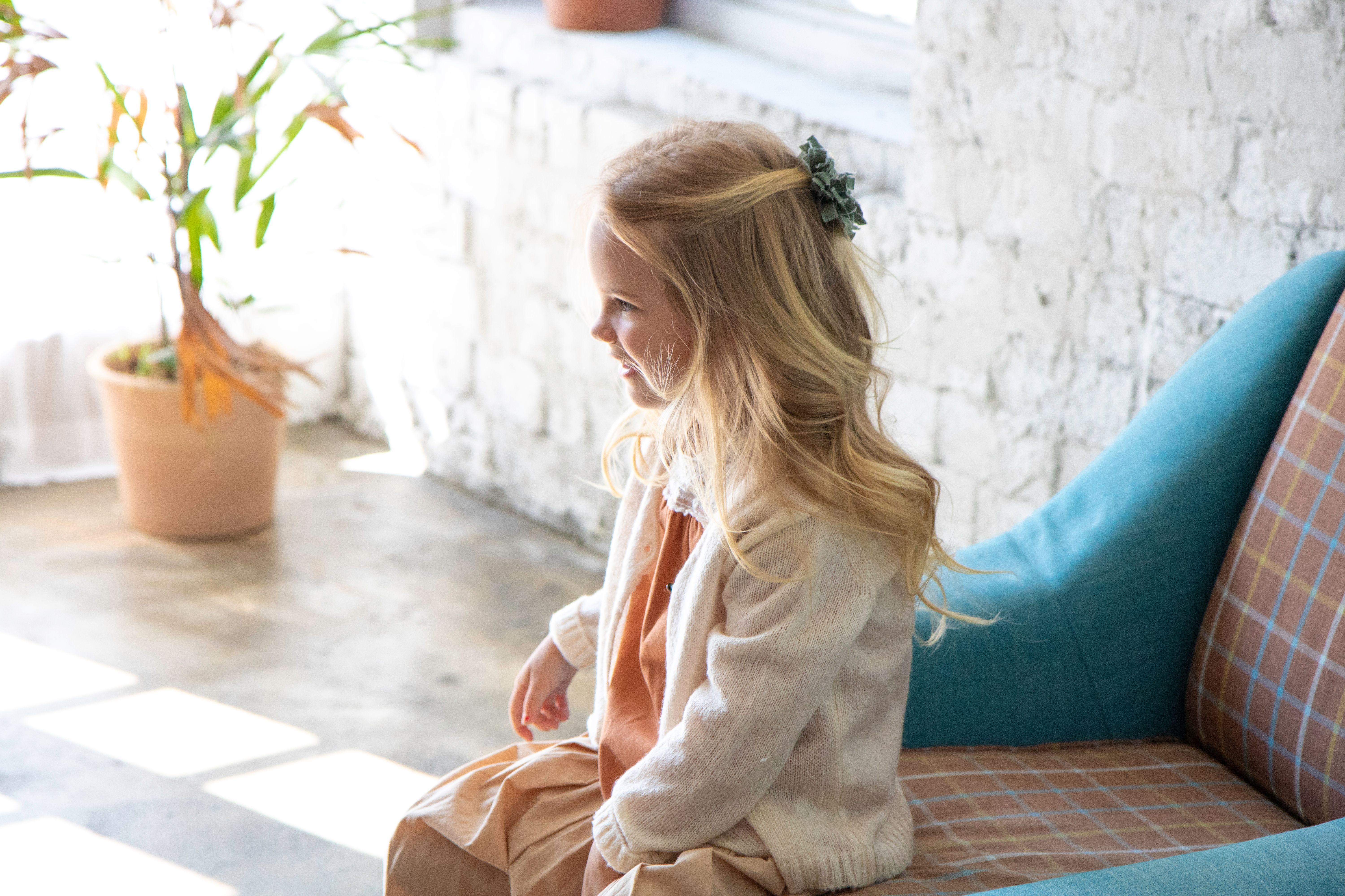 Little Girl with Blond Hair Sitting on Chair · Free Stock Photo