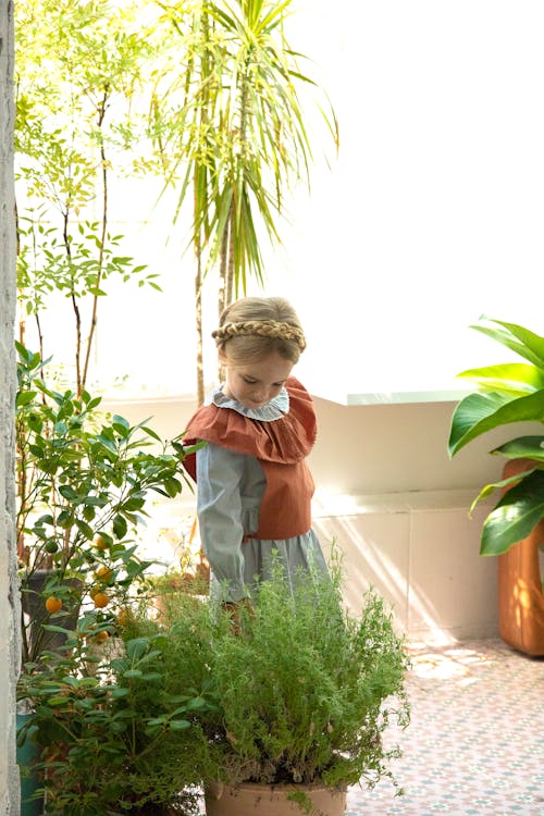 Girl Standing near Potted Plants